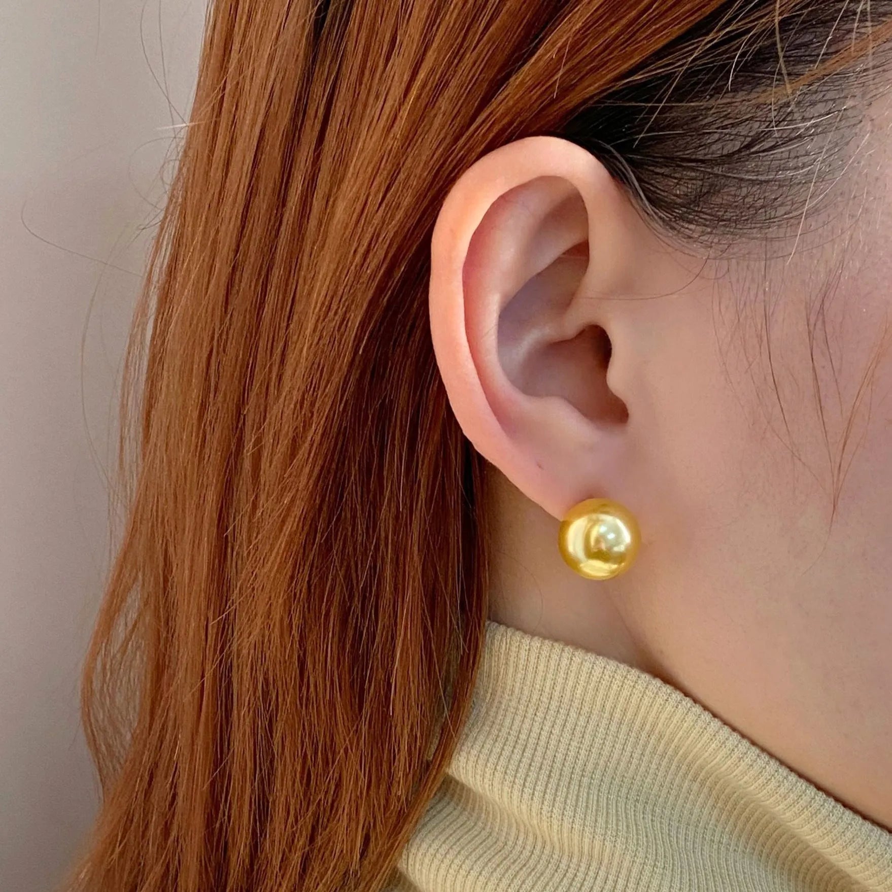 Women's geometric pearl stud earrings with silver settings and retro styling