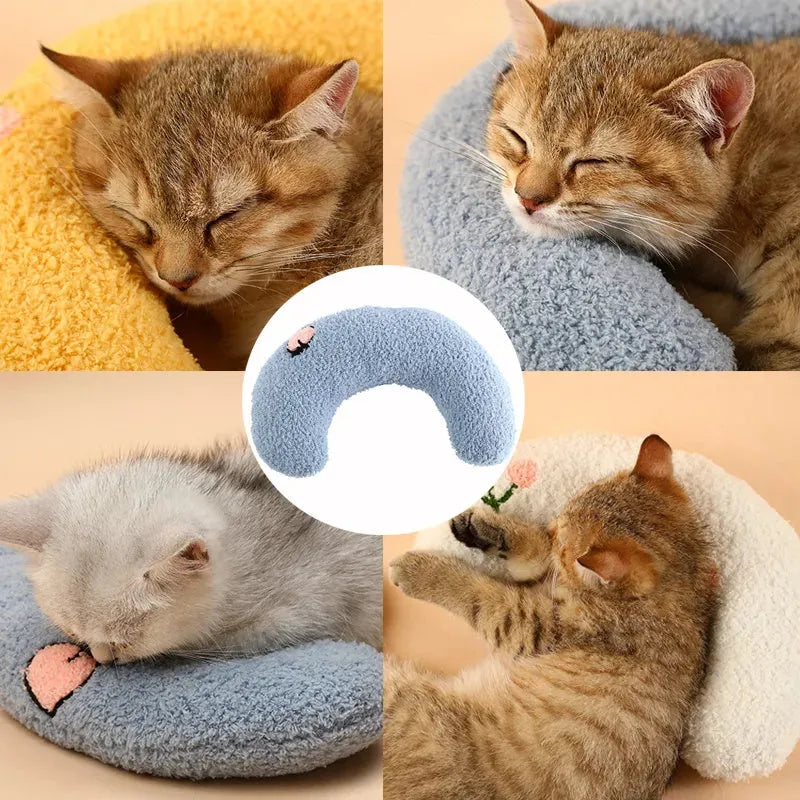 Small U-shaped plush pillow for cats and small dogs in blue, showing quilted faux fur texture.