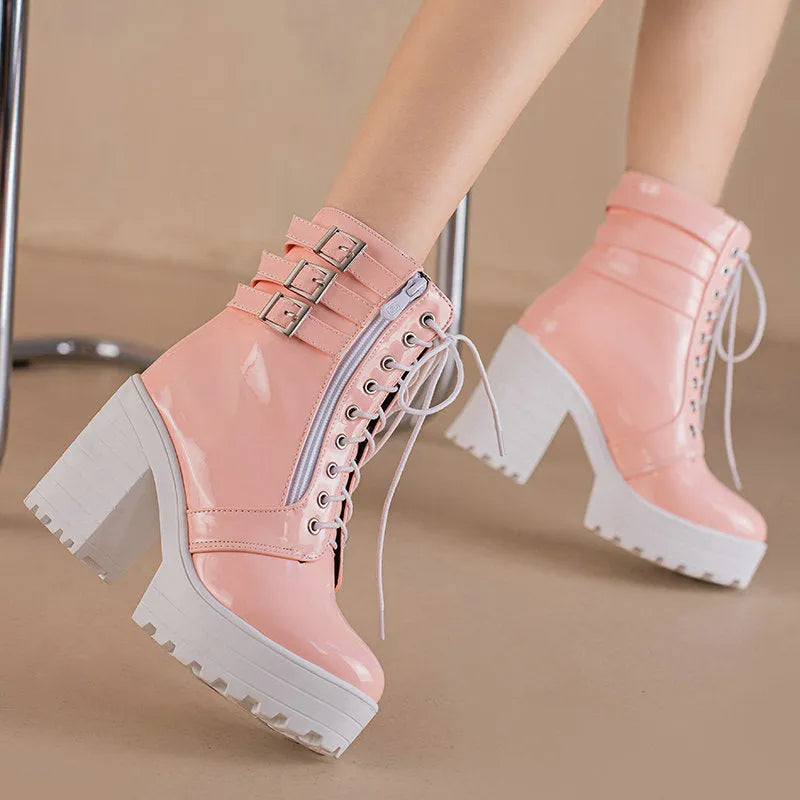 Women's black thick-heel ankle boots with lace-up front and round toe on a rubber sole.