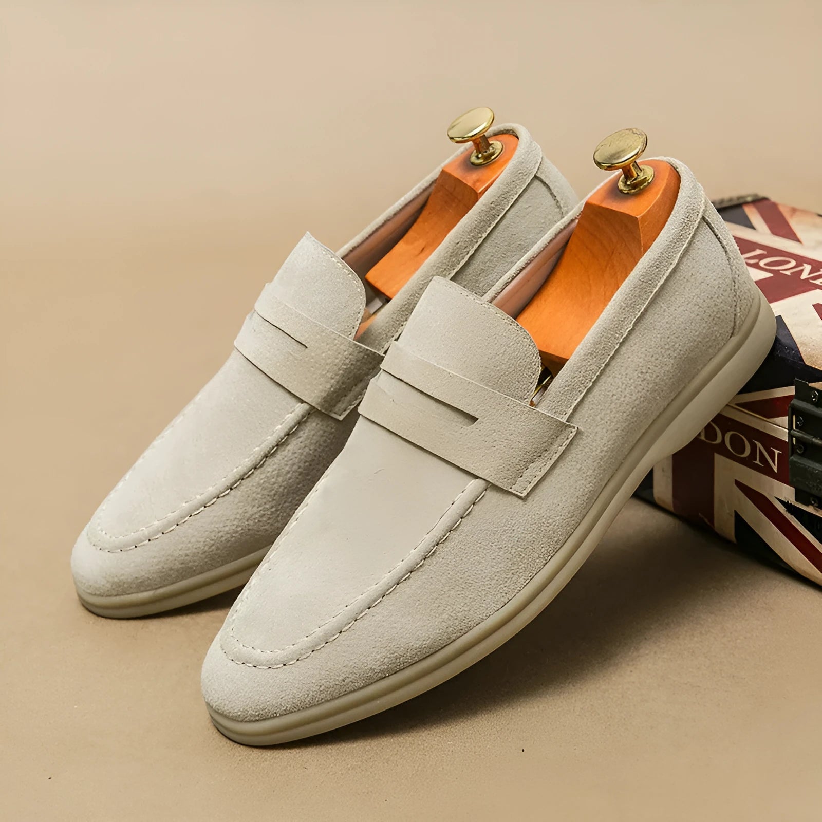 Men's beige leather slip-on casual shoes with a round toe and mid heel on a rubber sole.