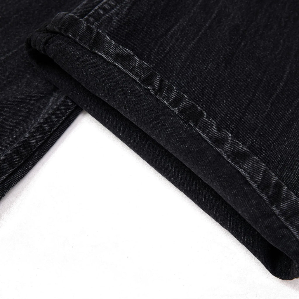 Black men's straight-leg jeans with a distressed lightning crack pattern on the legs.