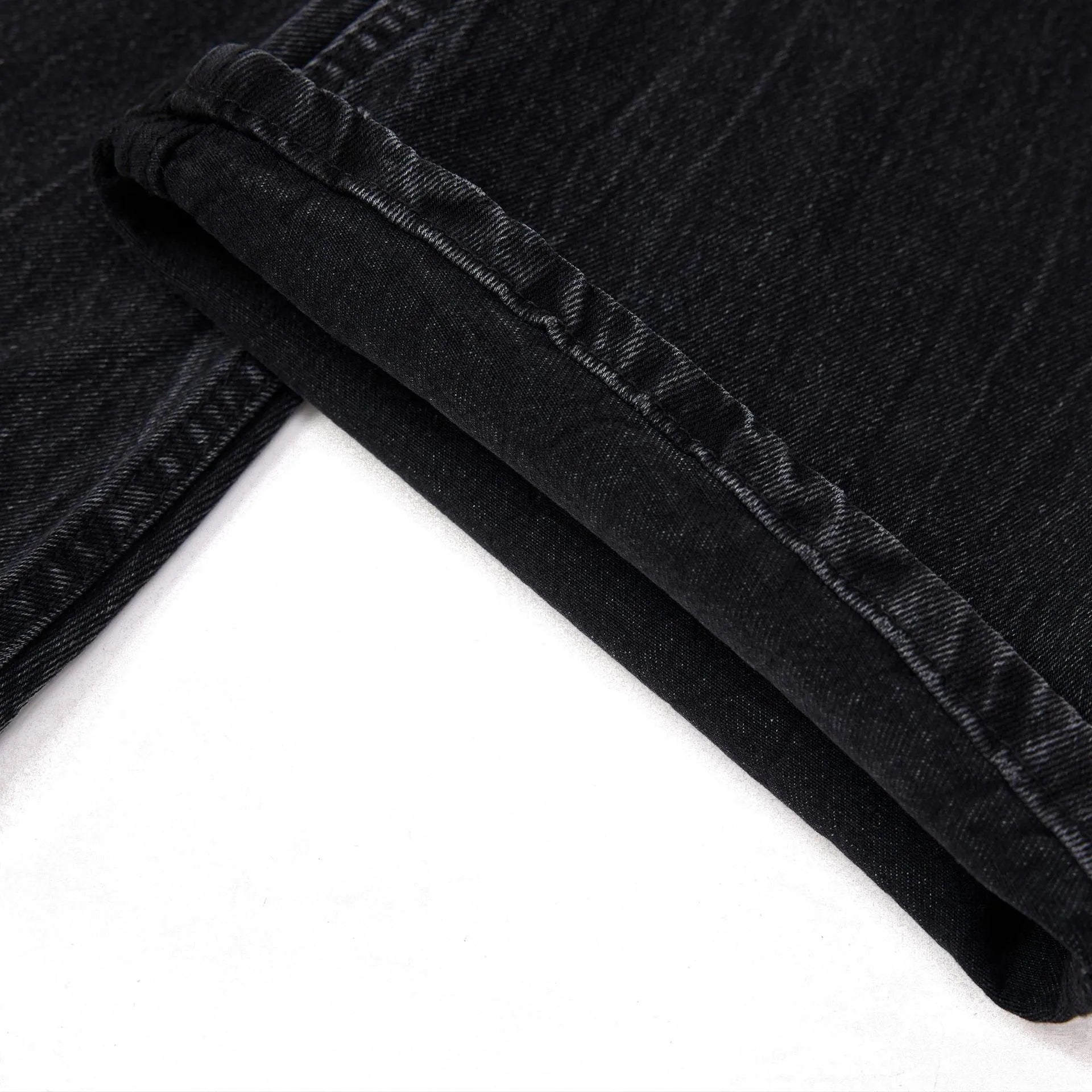 Black men's straight-leg jeans with a distressed lightning crack pattern on the legs.