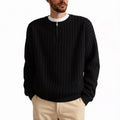 A grey men's half-zip texture knit sweater with a loose fit and long sleeves on a hanger.
