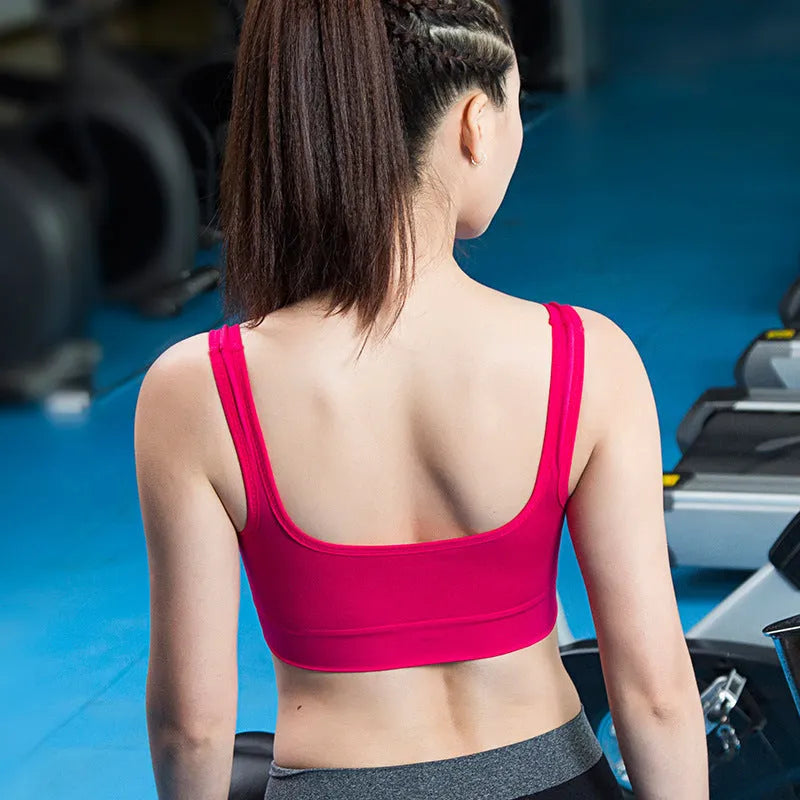 Women's reinforced sports bra in pink, shown with fixed double straps and thin mold cup.