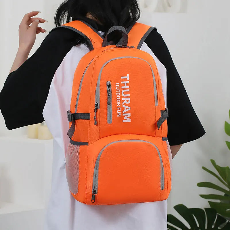 Large dark blue outdoor backpack with an air pillow belt, shown folded and unfolded.