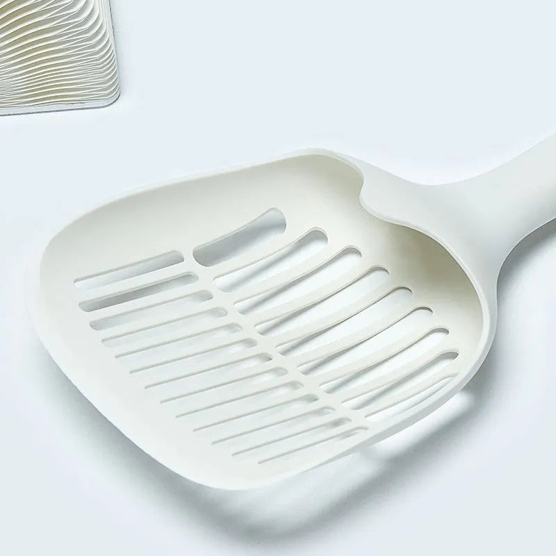 White plastic cat litter scoop with an attached rectangular base.