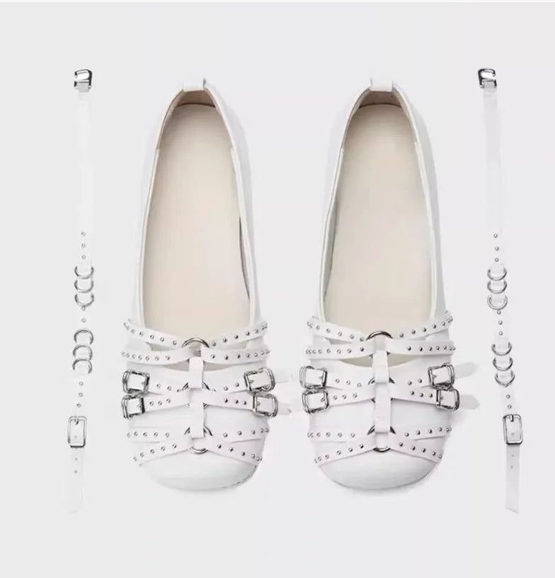 Women's black patent leather buckle pumps with a square toe and low flat heel on a white background.