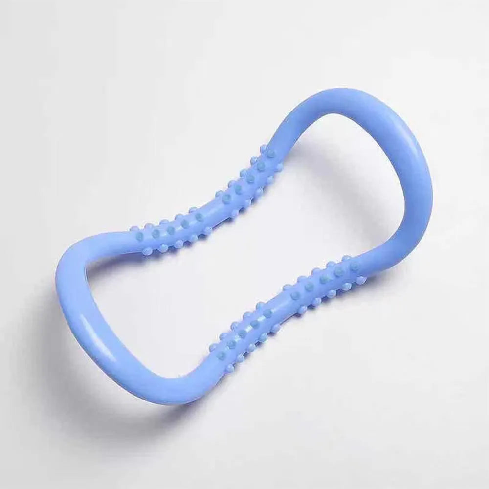 Purple, blue, and pink coloured yoga stretching ring for Pilates and back opening exercises.