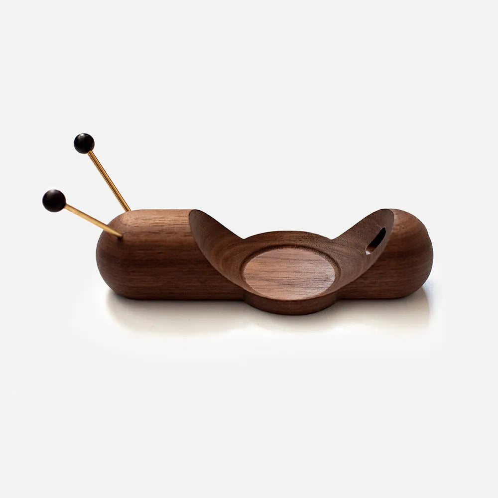 Coffee coloured non-slip desktop bracket for Apple HomePod speaker.