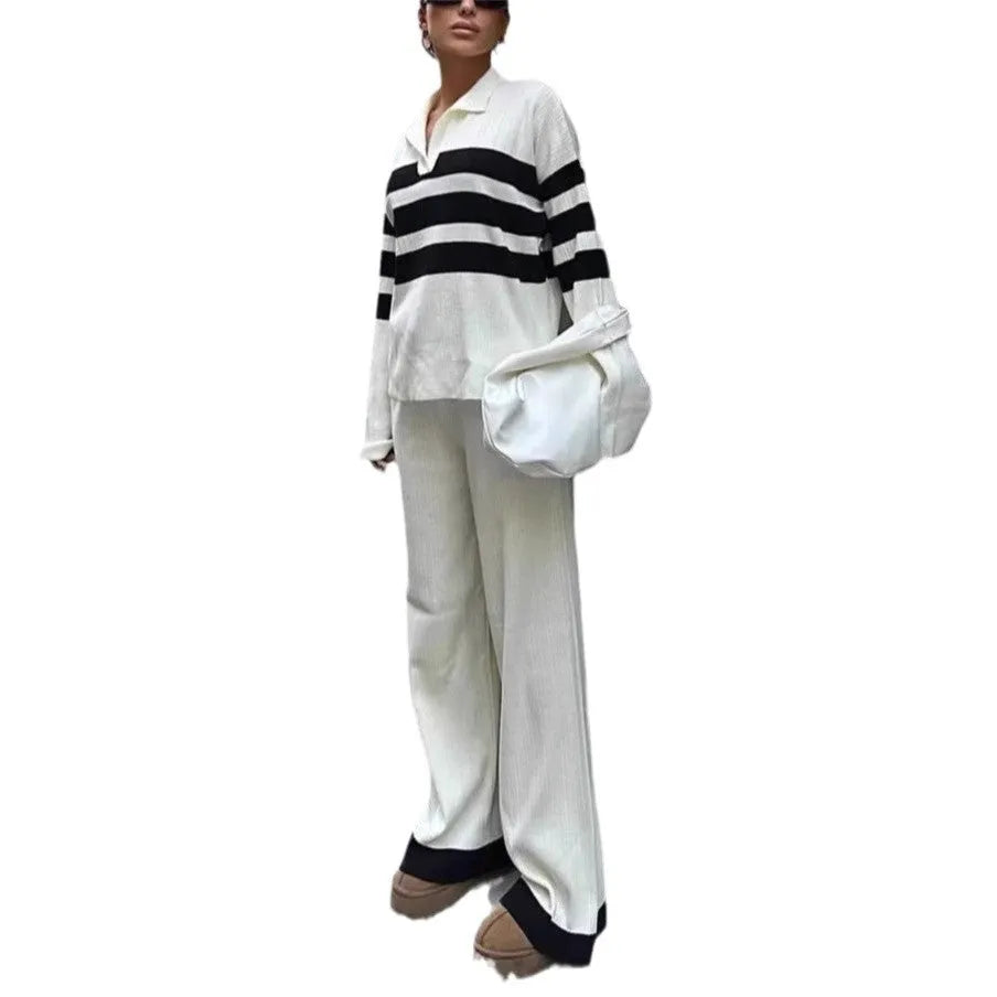 Women's black and white striped knitted top with polo collar and matching trousers casual set.