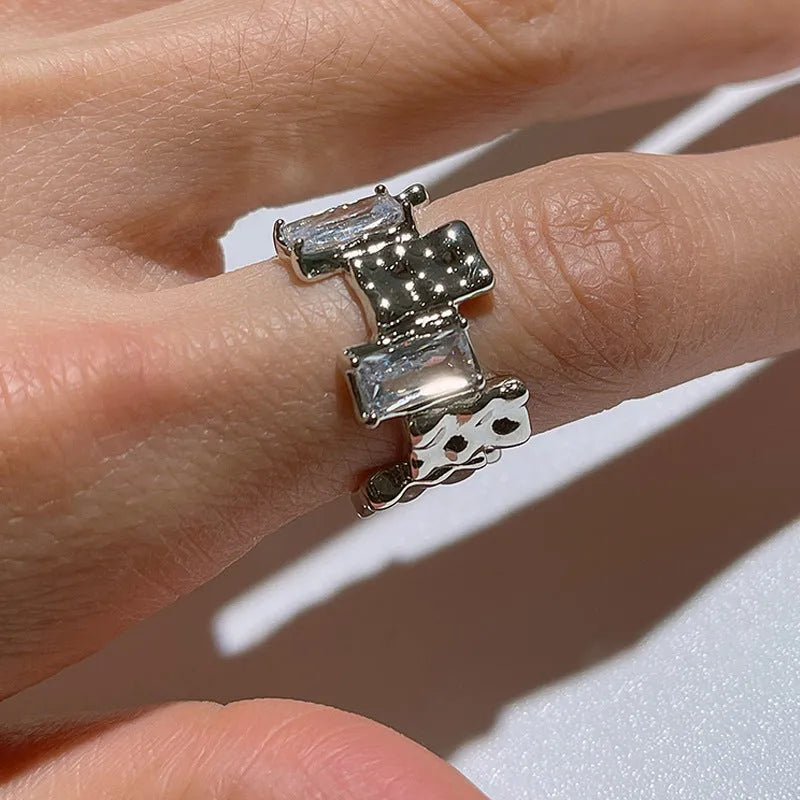 Silver geometric ring with cross zircon detailing and open gemstone setting