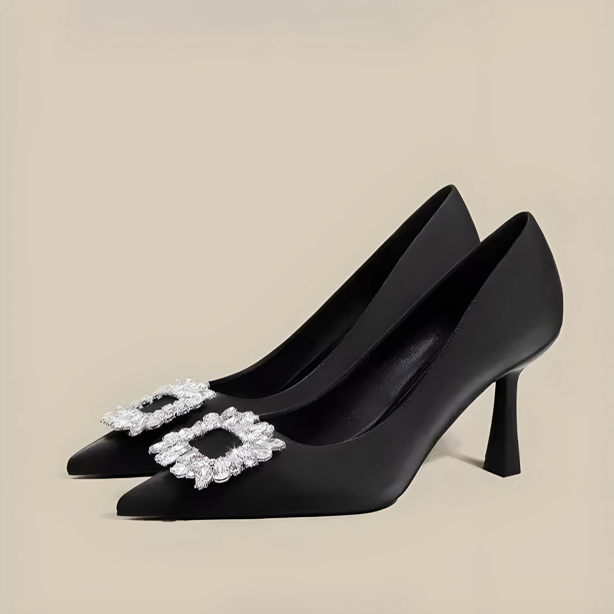 Women's pointed-toe stiletto heels in creamy white or black with a low-cut design and rubber sole.