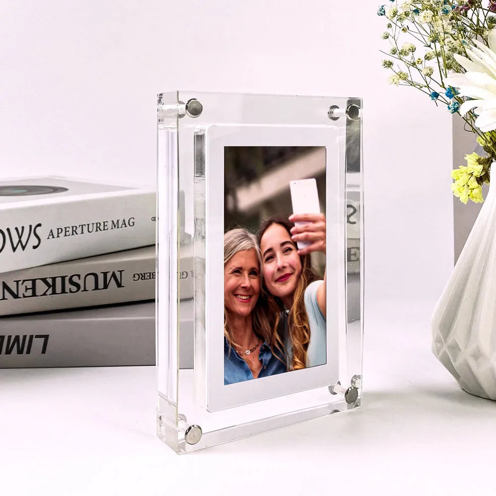 White vertical digital photo frame with 5-inch screen showing family photographs