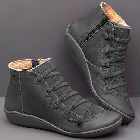 Women's flat casual booties in a round-toe design with a wedge heel, shown in a choice of colours.
