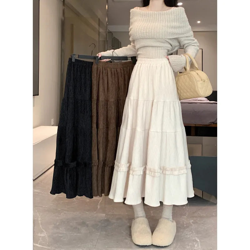 Beige corduroy A-line midi skirt with an elasticated waistband on a hanger.