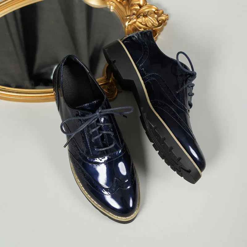 Women's black loafers with mirror sequin details, wedge heel, and lace-up oxford styling on a white background