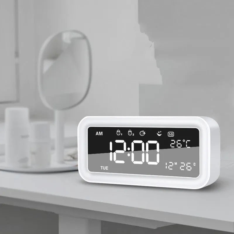 Rectangular blue LED atmosphere alarm clock with digital display on a wooden surface.