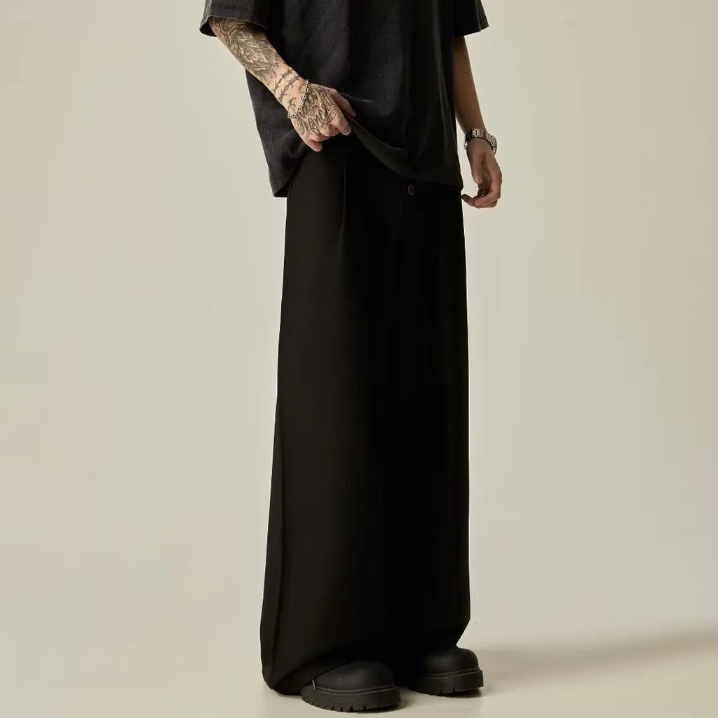 Men's solid colour wide-leg casual trousers in black, showing elastic waist and straight leg cut.