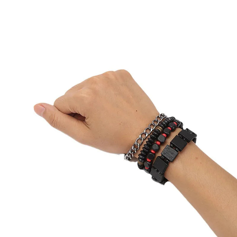 Set of four handmade retro woven alloy bracelets in different colours on a neutral background
