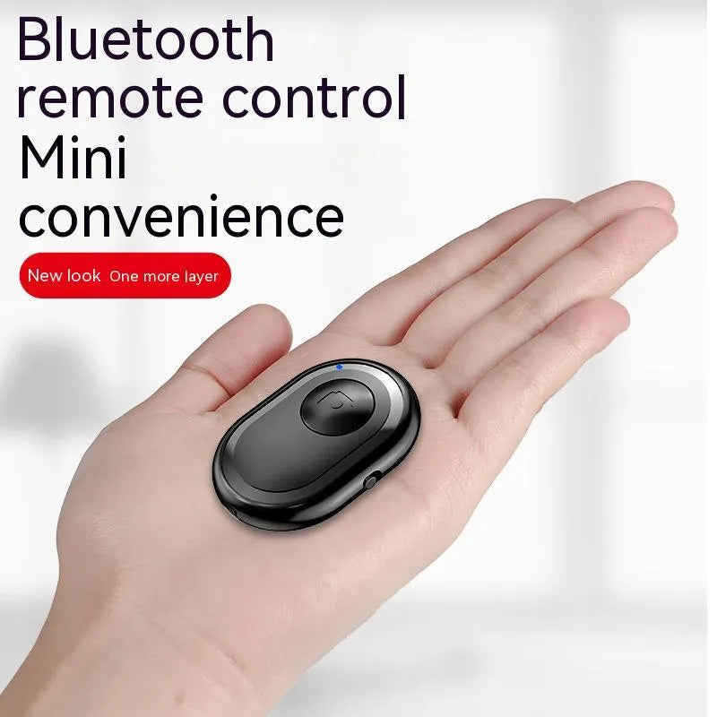 Small black wireless Bluetooth remote control for smartphone photography