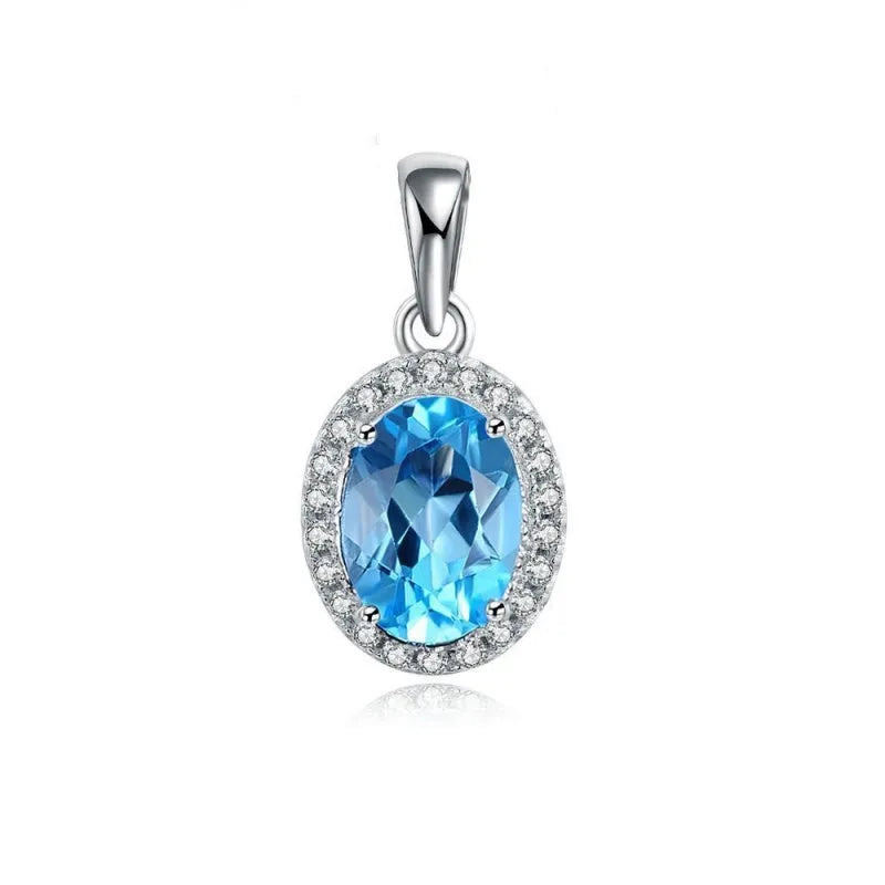 Four-piece sterling silver jewellery set with blue topaz gems showing geometric necklace, earrings, ring, and pendant