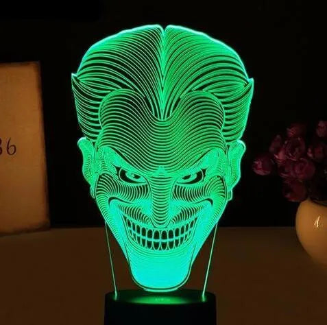 A 3D acrylic LED lamp emitting a gradient of colours, shown with its square base and remote control.