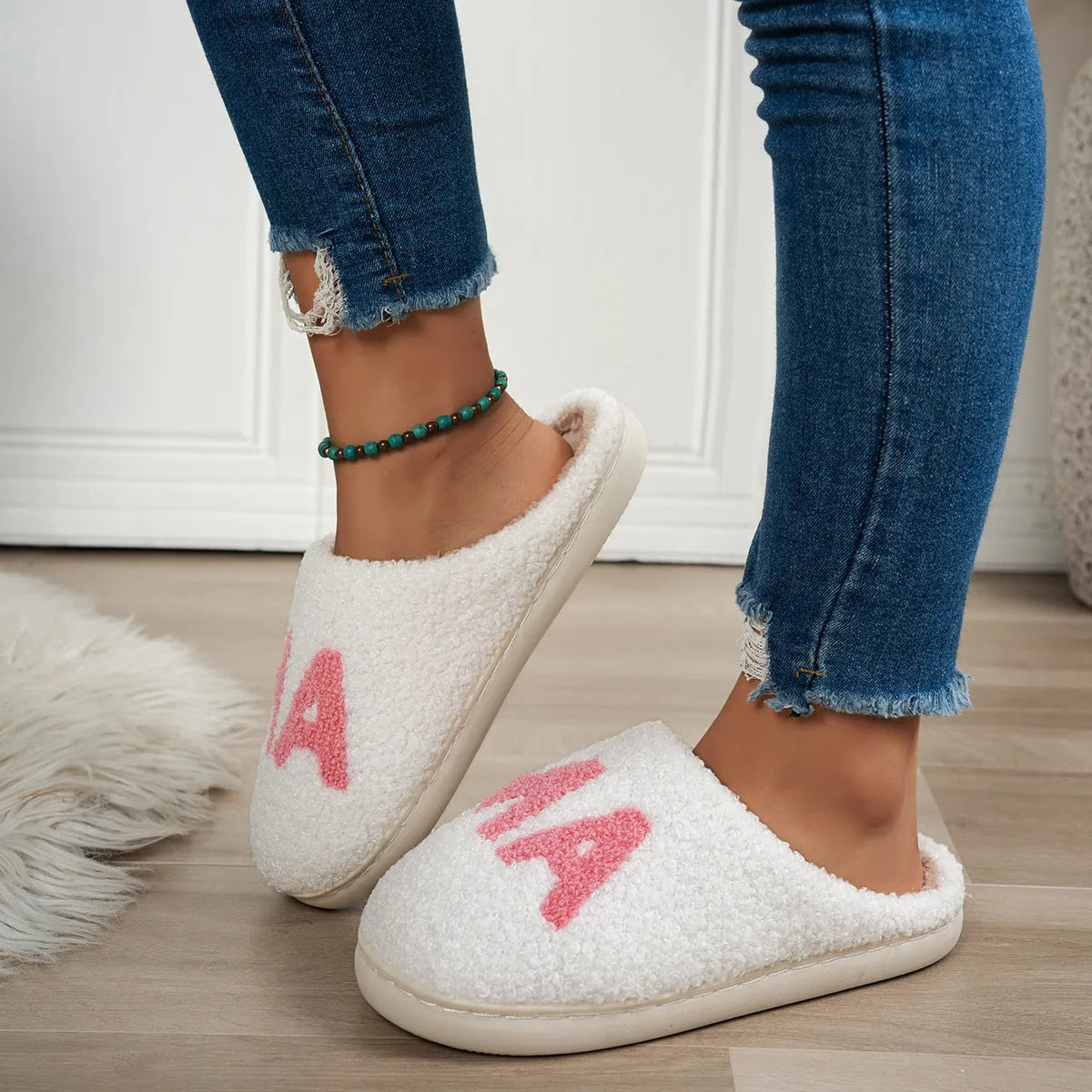 White plush cotton slippers with non-slip TPR sole on indoor floor