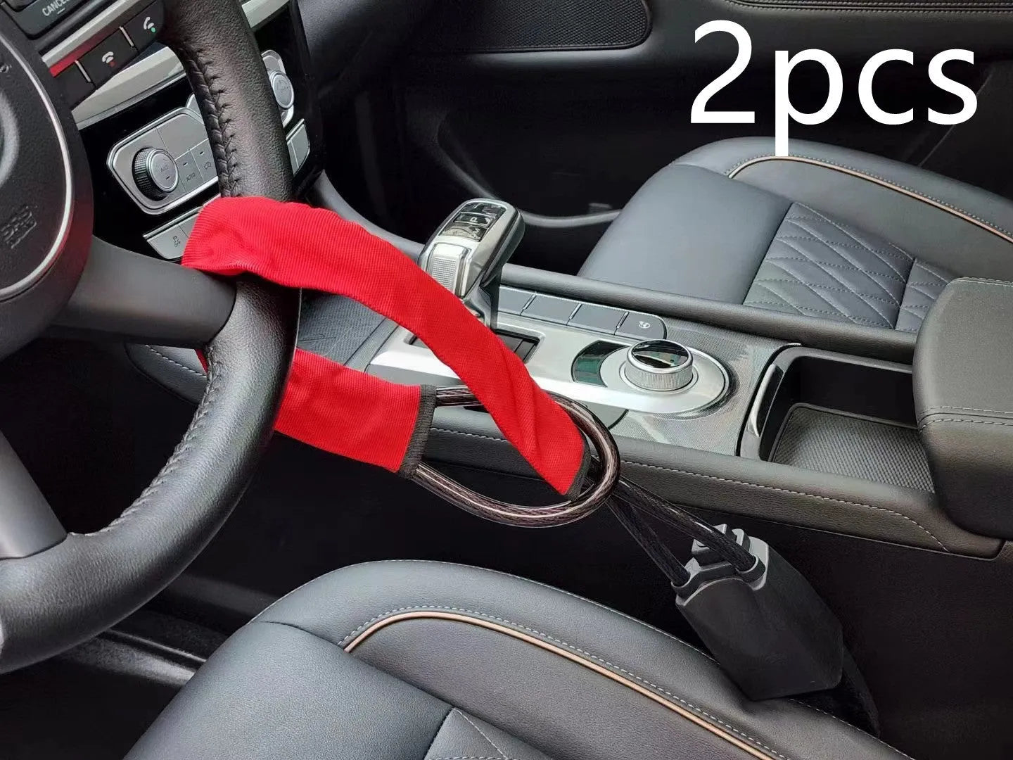 A red iron steering wheel lock with a copper core for General Motors cars, shown with its wire rope extended.