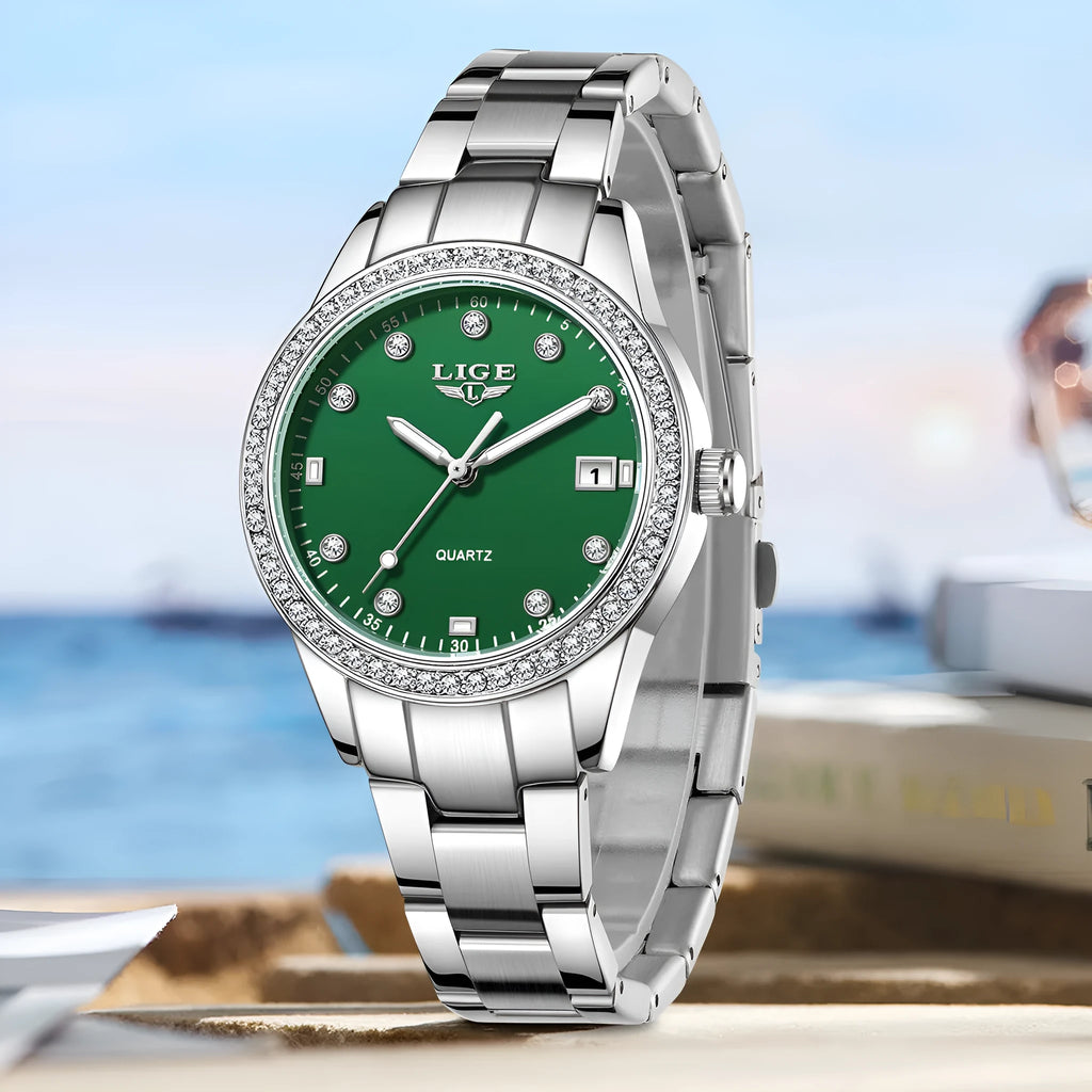 Women's silver stainless steel watch with diamond bezel and luminous hands on a 34mm round dial.