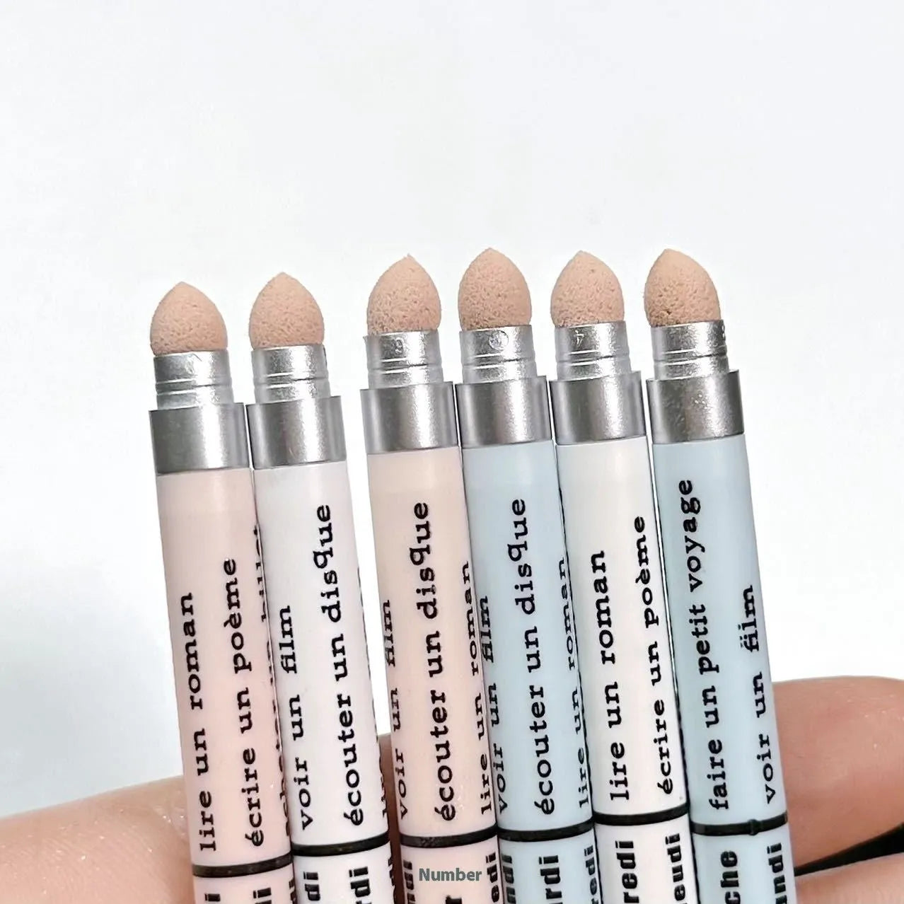 Waterproof 2-in-1 eye shadow pen showing various shades including gold, purple, and brown.