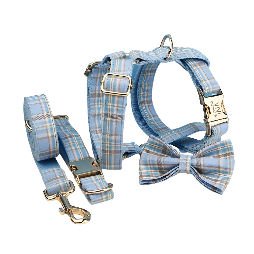 Sky blue grid forest pattern dog collar, leash, bow, and vest four-piece pet set laid out flat.