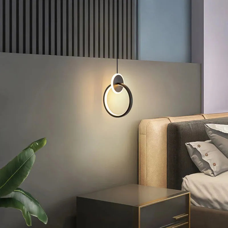 Modern black double ring Nordic pendant lamp hanging from ceiling with adjustable cable.
