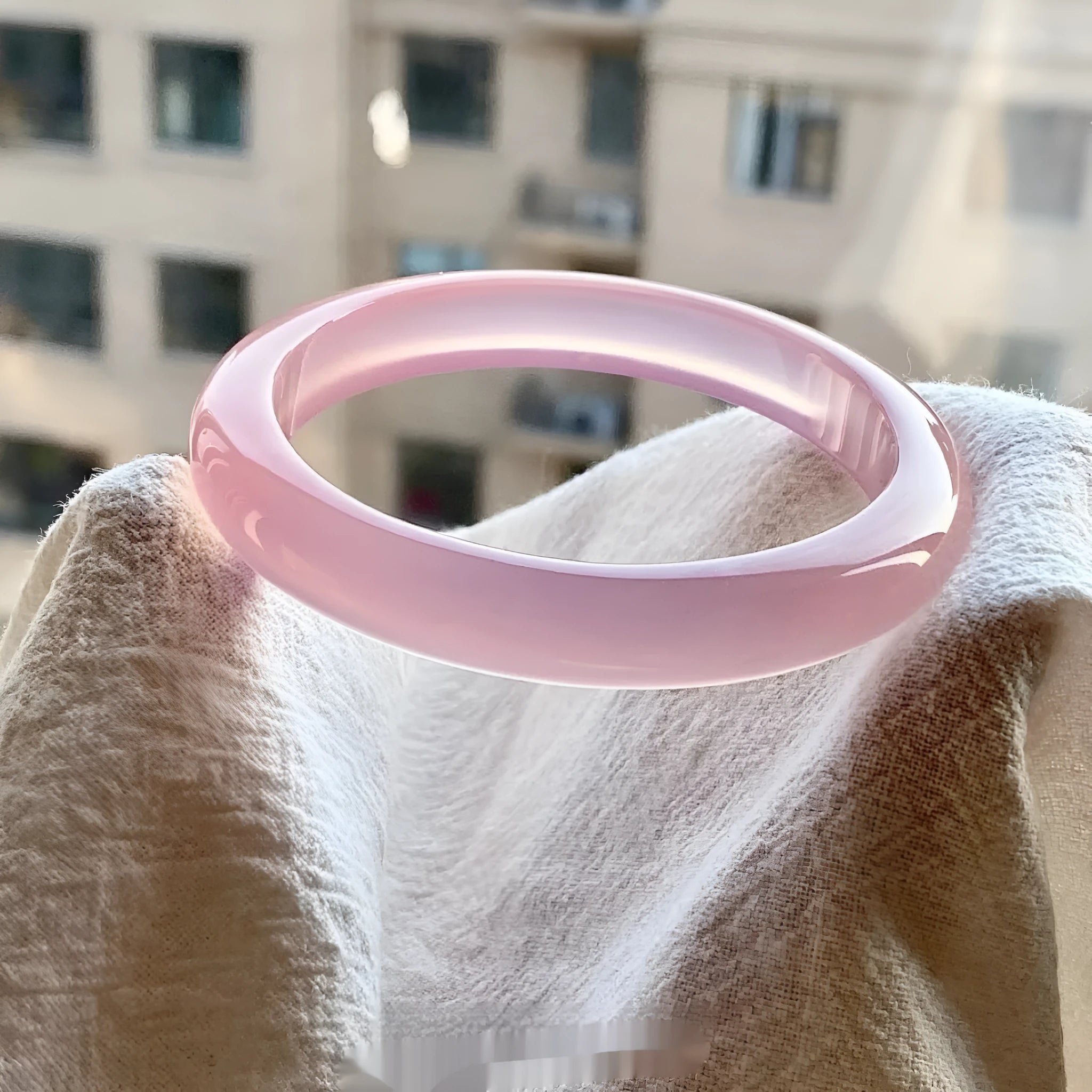 Natural agate wide tyre bracelet in a selection of colours including pink, blue, and green on a size chart showing 52mm to 62mm.