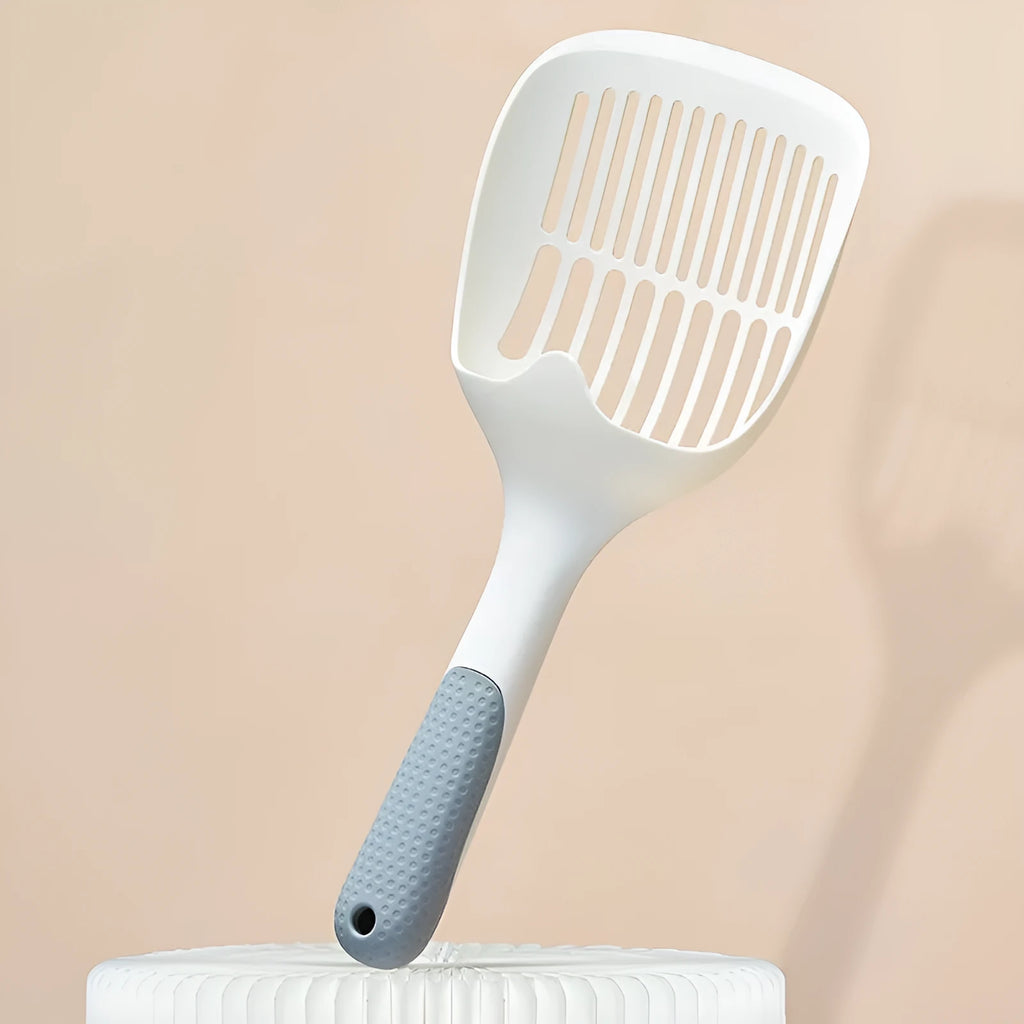 White plastic cat litter scoop with an attached rectangular base.