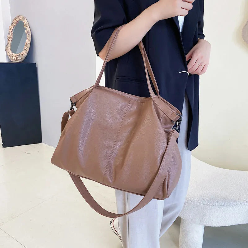 Large soft surface messenger bag in black with adjustable shoulder strap and zip opening