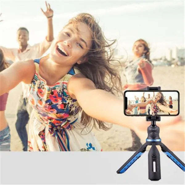Black desktop tripod holding a mobile phone, showing adjustable bracket and plastic-aluminium construction