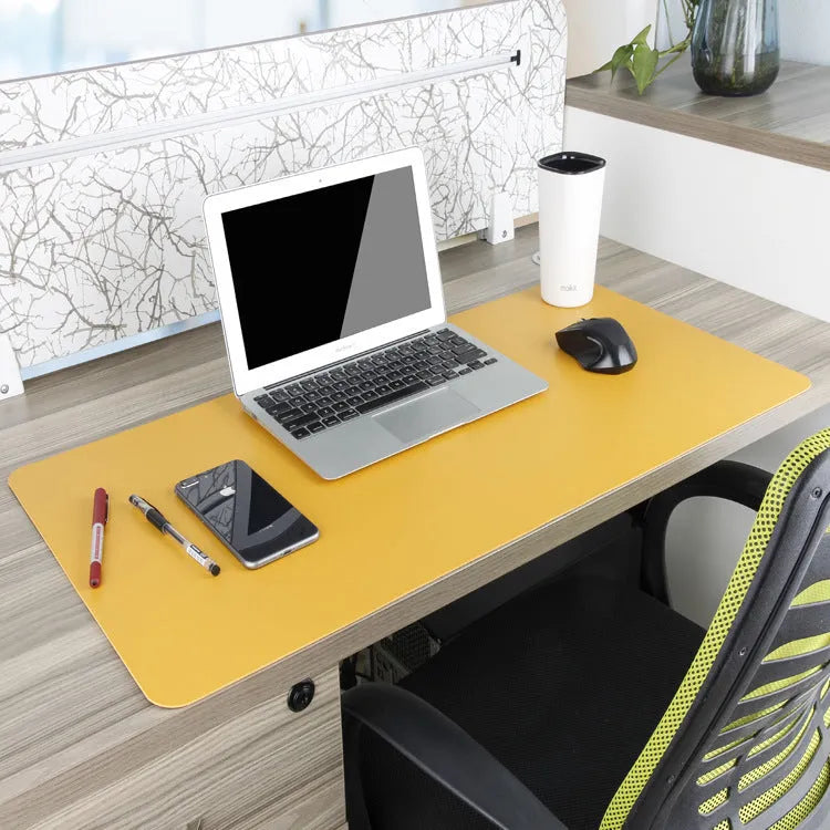 Oversized double-sided PU mouse table mat in sapphire blue and yellow on a desk