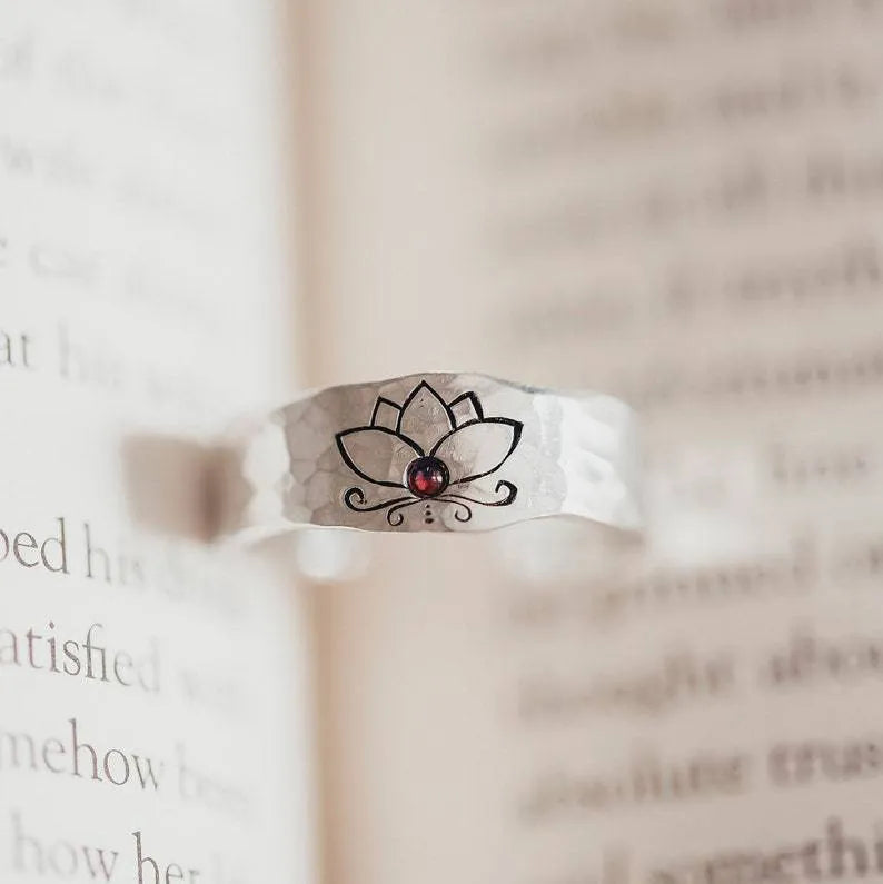 Silver alloy electroplated lotus ring on a light background, glossy finish, minimalist design