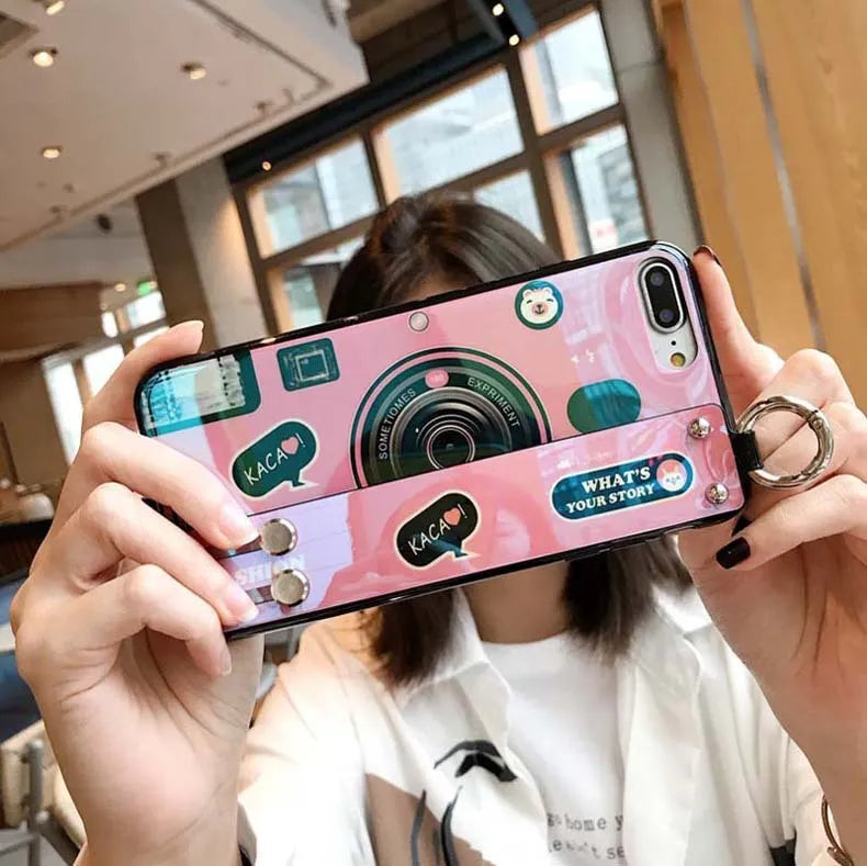 TPU iPhone case with retro camera design in blue or pink, back cover style, optional wrist strap.