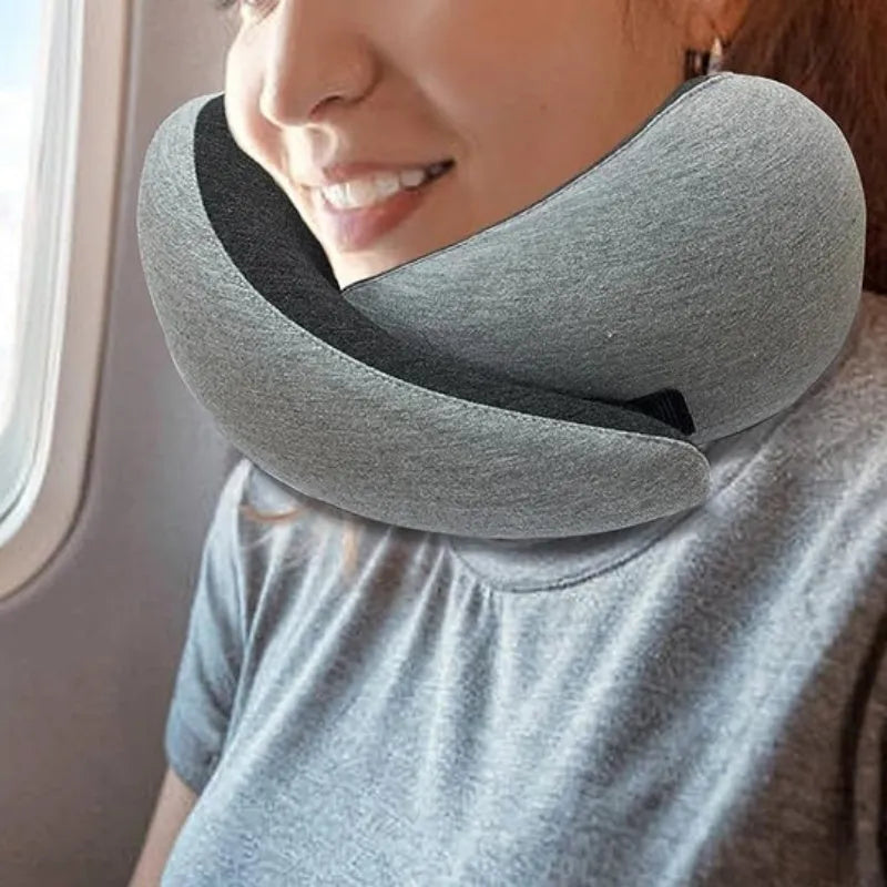 Navy blue U-shaped travel neck pillow with memory foam filling shown rolled for compact storage