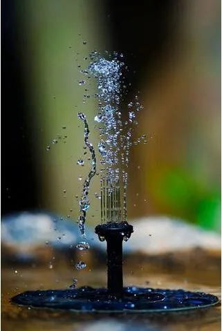 Black solar-powered water fountain pump with four different spray nozzles on a white background