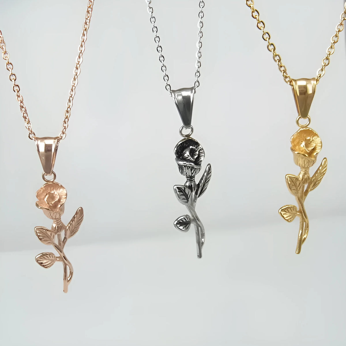 Polished stainless steel men's necklace with cross and rose pendant, gold colour, on display