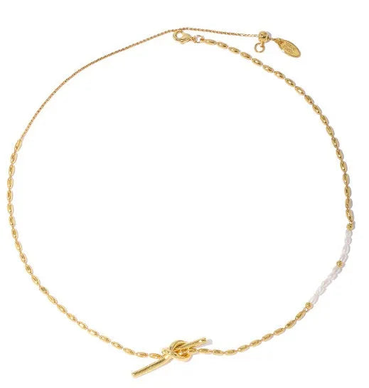 Gold electroplated natural real pearl necklace with copper geometric pendant and ring-line design on white background