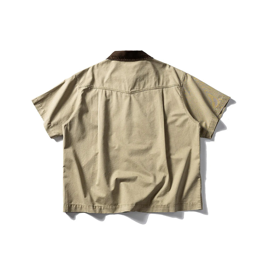 A khaki-coloured, loose-fitting, short-sleeved cotton shirt styled as washed overalls for teenagers