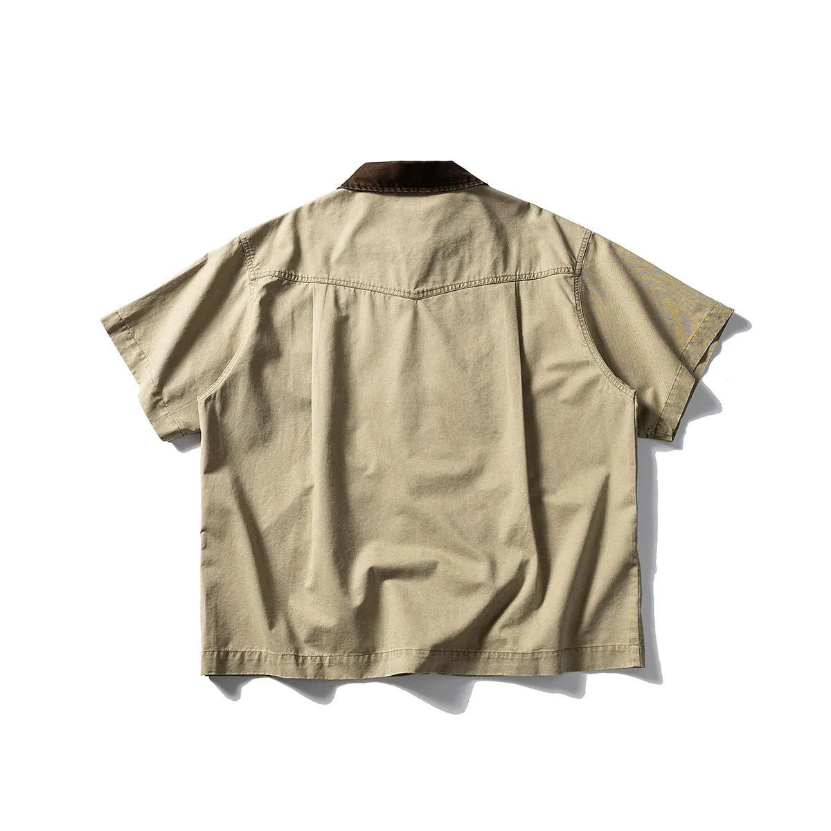 A khaki-coloured, loose-fitting, short-sleeved cotton shirt styled as washed overalls for teenagers