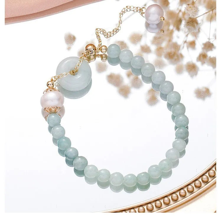 Women's Korean style crystal bracelet showing options with jade pendant or coloured stone safety buckle.