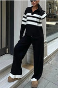 Women's black and white striped knitted top with polo collar and matching trousers casual set.