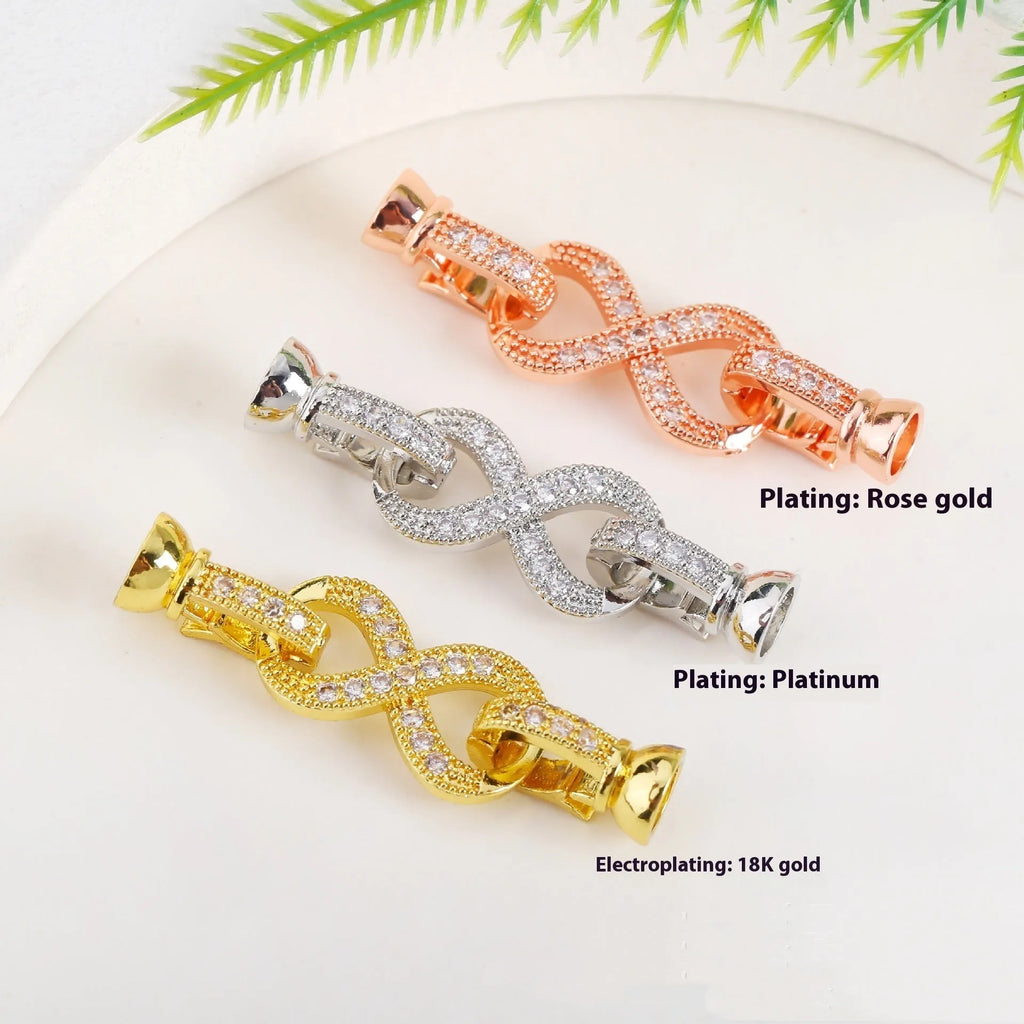 Small gold-plated necklace chain buckle on a white background, a DIY jewellery finding.