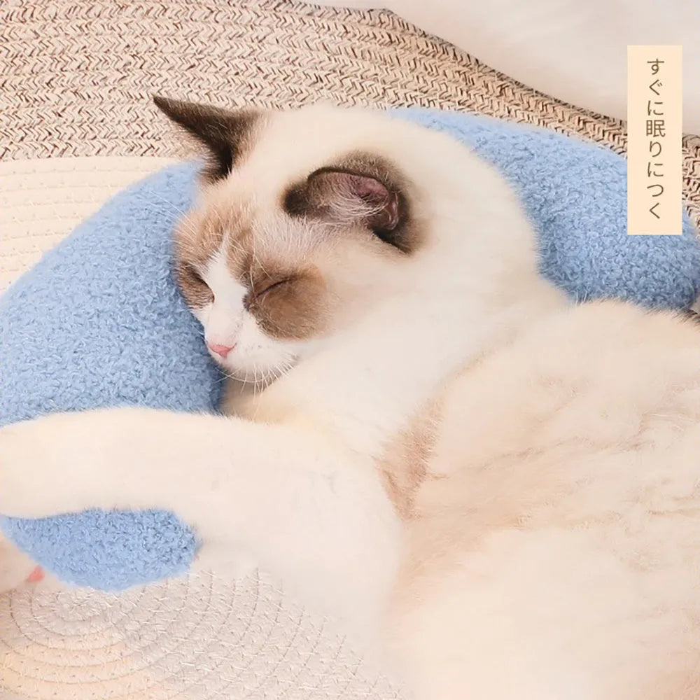 U-shaped blue cat pillow with adjustable neck collar on a sofa