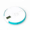 Blue 7-compartment alarm clock pill dispenser showing time display and open compartments.